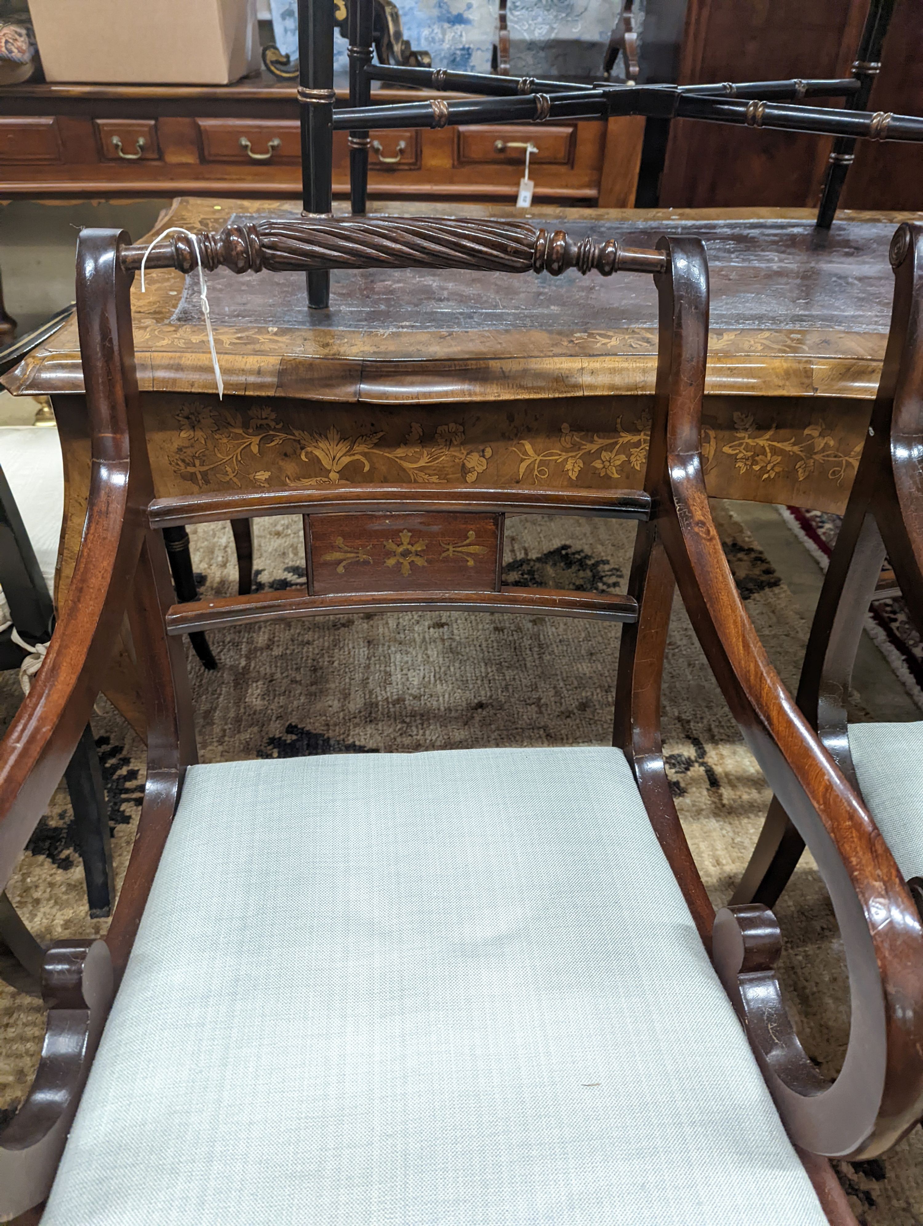 A pair of Regency style brass inlaid mahogany elbow chairs, width 48cm, depth 48cm, height 88cm